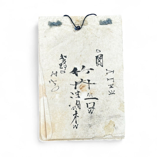 Edo-Meiji handwritten Japanese notebook with hentaigana cursive script on washi paper, tied with string binding.